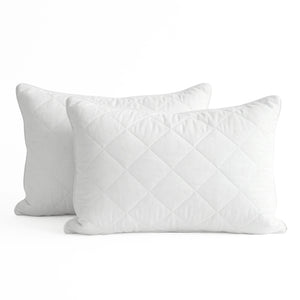 Two white quilted pillows on a white background