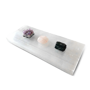 Decorative stone tray with crystals on a white background